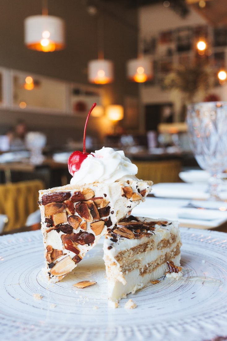 Almond Nougat — soft layers of cookie and sweet cream topped with almonds.