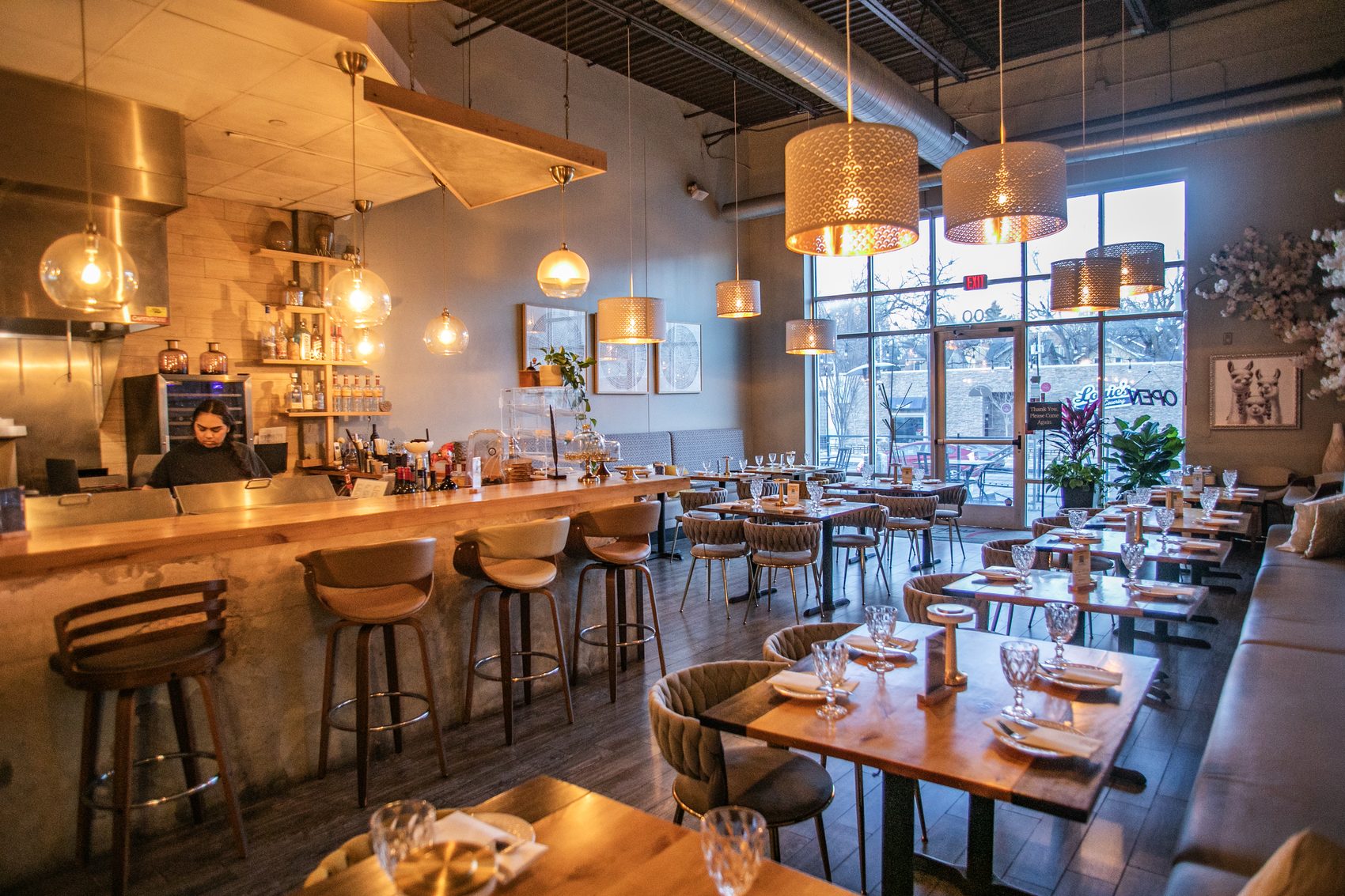 The Panka bar lit by warm pendants — set within the open dining room.