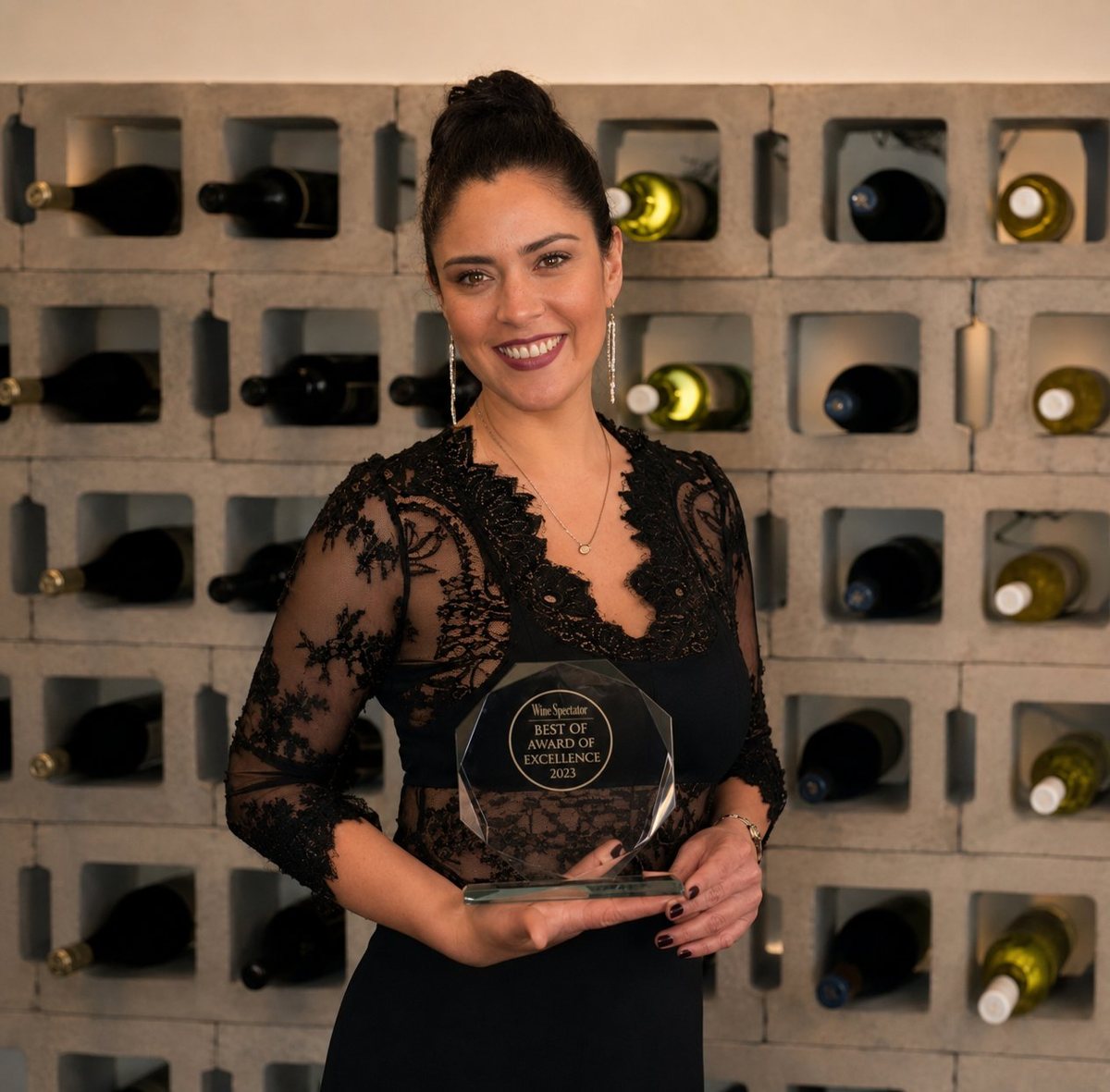 Mariela Maya, founder and chef-owner of Panka, holding an award.